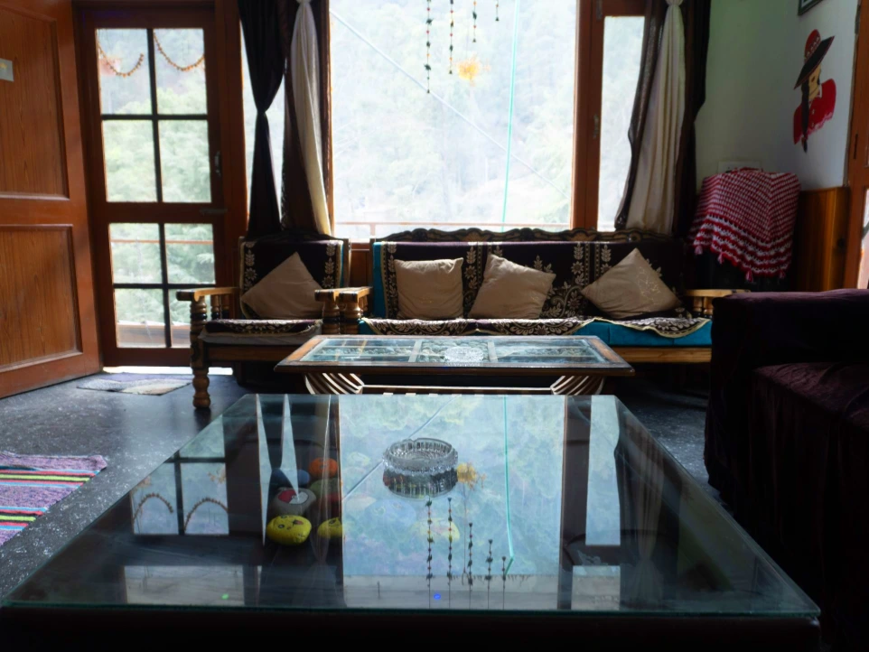 Cozy interior seating area at Tirthan Midpoint Homestay